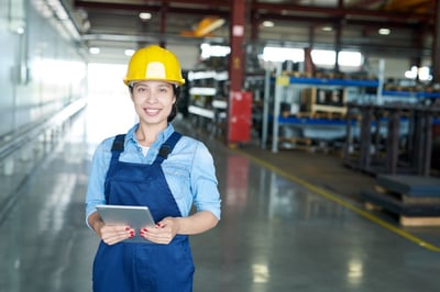 Smiling industrial worker holding a tablet