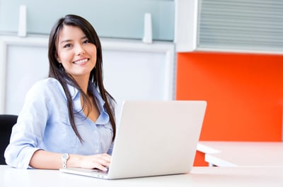 Smiling engineer at a computer