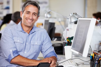 Smiling engineer sourcing on a computer