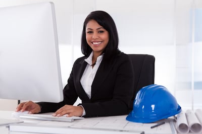 Smiling minority female engineer at a computer