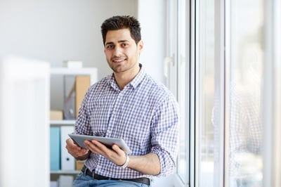 Smiling male procurer with a tablet