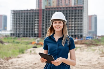 Smiling female procurer at a construction site