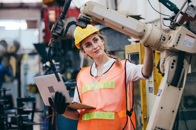 Female Engineer Inspecting a Robotic Arm