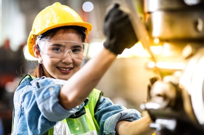 Asian-American female industrial worker smiling