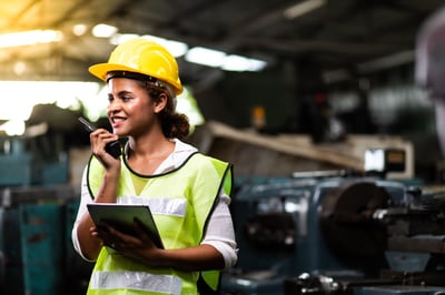 Smiling female industrial worker with a tablet