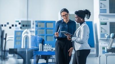 Female professionals looking at a tablet