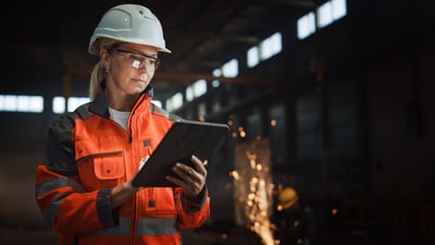 Smiling female industrial worker with a tablet