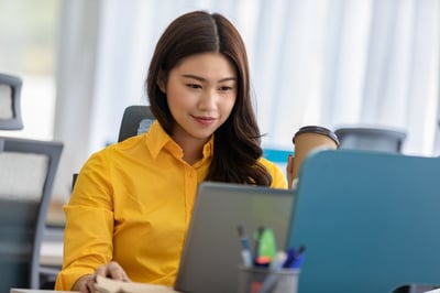 Smiling minority female engineer at a computer