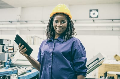 Smiling Black Female Engineer Holding a Tablet