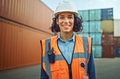 Smiling female industrial worker with a hard hat