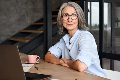 Smiling older businesswoman with a computer