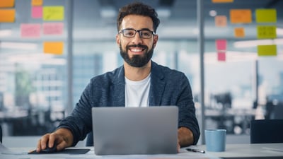 Smiling man at a computer