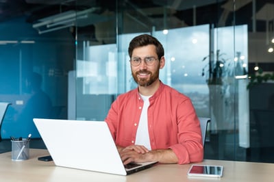 Smiling businessman with a laptop