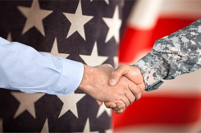 Shaking hands in front of the American flag