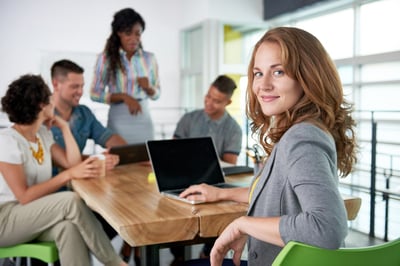 Smiling businesswoman at a computer