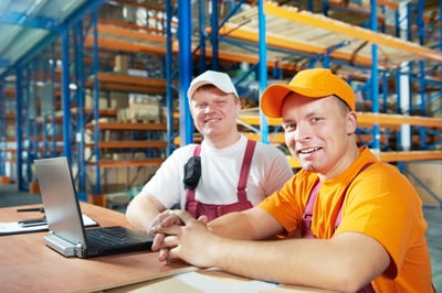 Two workers sourcing in a warehouse